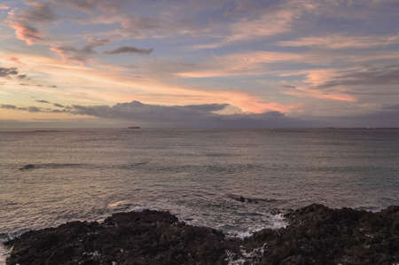 Seascape with nautical vessels afar in the sea and scenic skies at dusk on Jeju islandの写真素材