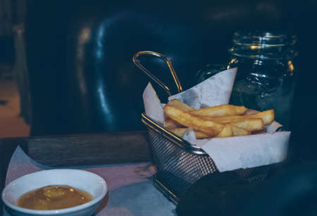 Serving of freshly fried potato and sauceの写真素材