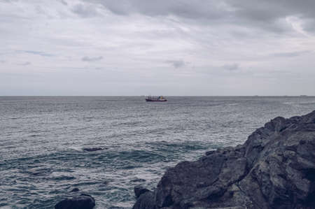 view from Busan's shore on small  cruise boat on gloomy dayの写真素材