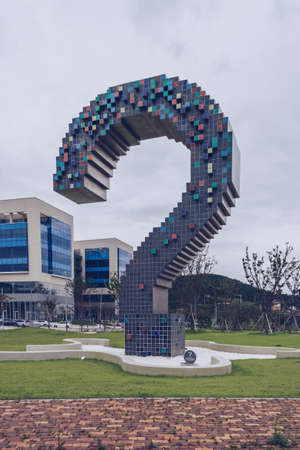 Busan, South Korea, September 12, 2019: modern sculpture of question in one of the parks with cityscape and overcast skiesのeditorial素材