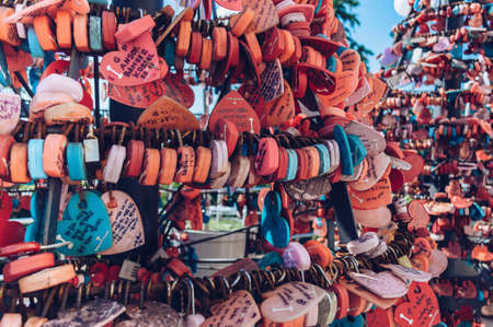 Busan, South Korea, September 14, 2019: close up view of heart shaped locks with wishes and names on tags near Busan towerのeditorial素材