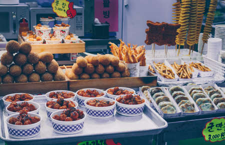 Busan, South Korea, September 14, 2019: variety of korean street food on display: corn dogs, fries, fried potato, fried chickenのeditorial素材