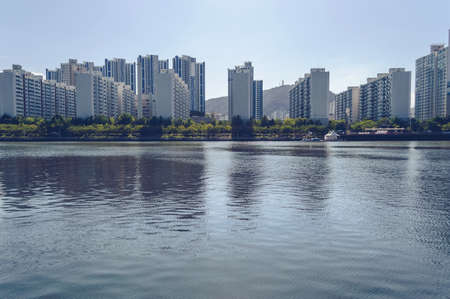 Typical modern apartments of South Korea with canal in front of themの写真素材