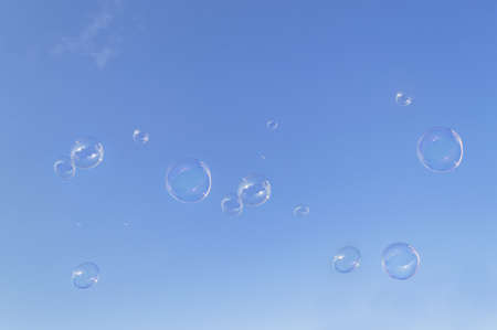 Blowing large soap bubbles using big plastic wand