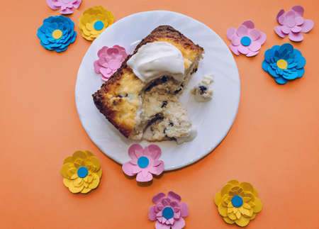 view from above on piece of cottage cheese casserole with sour cream on colorful background with...