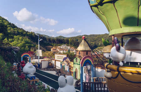 Pocheon, South Korea â 10 May, 2017: fantasy place with colorful buildings and sculptures at Herb Island with mountains and cloudscape on backgroundのeditorial素材