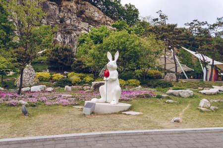 Pocheon, South Korea â 10 May, 2017: sculpture of white rabbit holding red tulip at Pocheon Art Valleyのeditorial素材