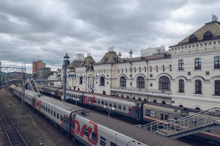 Vladivostok, Russia - October 05, 2020: cityscape view with  exterior of railway terminal and trains on the railroad tracks on gloomy dayのeditorial素材