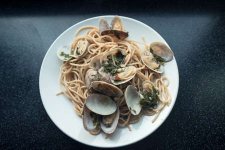 top view of freshly homemade seafood pasta on white palteの写真素材