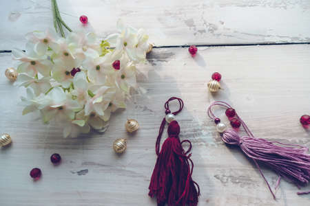 decorated tassels, colorful and elegant beads, blooming white hydrangea flowersの写真素材