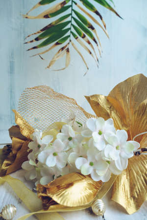 luxurous tropics concept layout with palm leaf blooming hydrabgea and golden liliesの写真素材