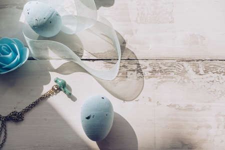 Easter decorative eggs with small enameled bird on chain flower and organza ribbonの写真素材