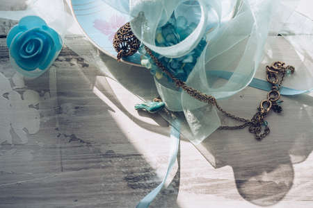 enameled bird pendant with organza and atlas ribbons on wooden backgroundの写真素材