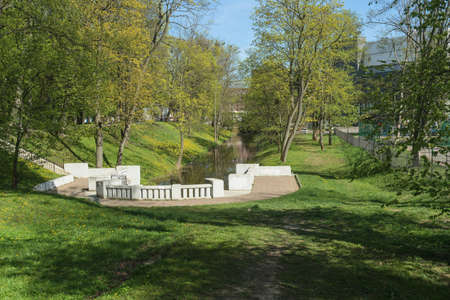 park with small canal and staircase in Kaliningrad on sunny spring dayの写真素材