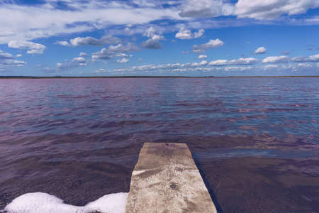 small wooden pier like plank with majestic pink lake Pechatnoe view in Altai region in Russiaの写真素材