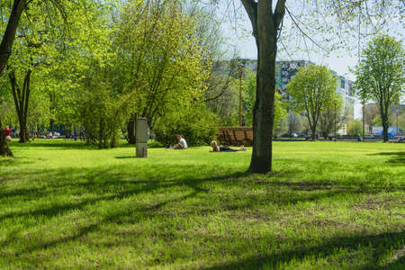 Kaliningrad, Russia - May 10, 2021: lying down and sitting on the grass people at Kants island park on warm spring dayのeditorial素材