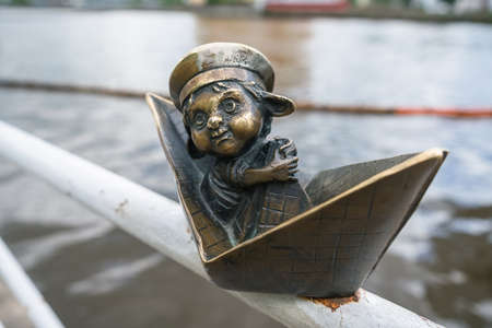 Kaliningrad, Russia - may 14, 2021: Homlin boy in paper boat small bronze sculptureのeditorial素材