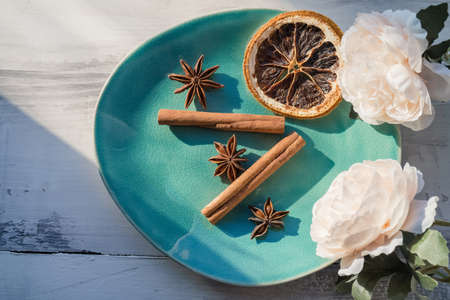 plate with several spices used for mulled wine and other cold weather drinks decorated with peony flowersの写真素材