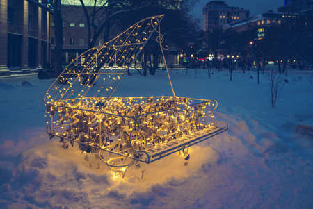 Novosibirsk, Russia, december 18, 2021: illuminated piano sculpture in the square near academic...