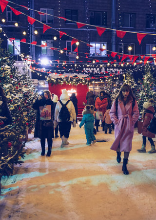 Novosibirsk, Russia, december 18, 2021: people walking at place decorated by local street food stalls for winter holidaysのeditorial素材