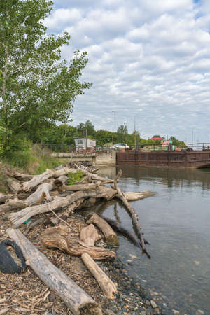 snags dump at teh river Ob shore with part of rusty barge platformの写真素材