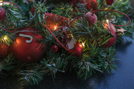 close up of christmas wreath wooden decor berries and christmas ballsの写真素材