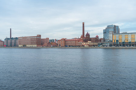 cityscape of gloomy Saint petersburg with Neva river and red brick buildingsの写真素材