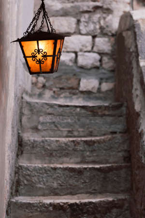 Lantern hanging above a stone staricaseの写真素材