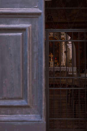 Half open church entrance with altar in the backgroundの写真素材