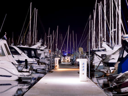 Pier in a marina with many boats dockedの写真素材