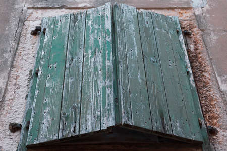 Weathered green window shutterの写真素材