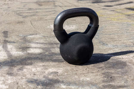 Kettlebell in summer on concrete