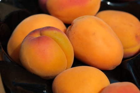 Apricots in a basket on a market stall, closeup of photoの写真素材