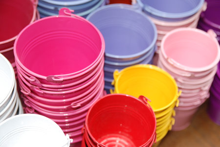 Colorful plastic buckets on a market stall, closeup of photoの写真素材