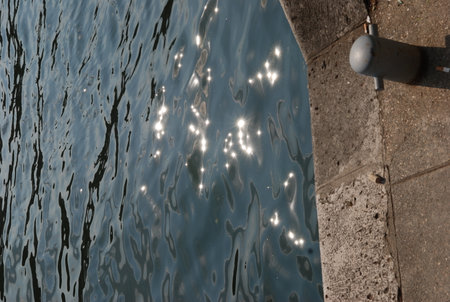 Reflection of the sun on the surface of the water in the poolの写真素材