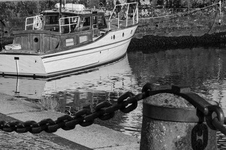 Fishing boat moored to a pier in the harbor. Noir et blanc.の写真素材