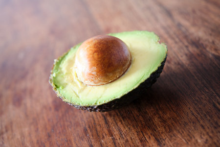 Avocado on a wooden table. Shallow depth of field.の写真素材