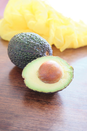Avocado fruit on wooden table. Healthy food. Vegetarian food.