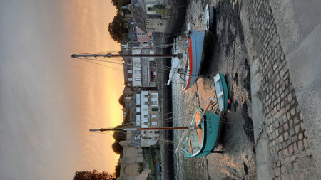 3D CG rendering of seaside village and fishing boats at sunsetの写真素材