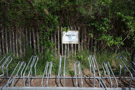 Bicycle parking sign in the forest. Bamboo fence background.の写真素材