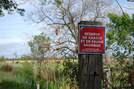 A sign warning people not to enter the area. The sign is on a wooden post.の写真素材