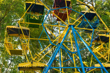 Colorful vintage ferris wheel among the treesの写真素材