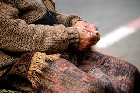 Close up of persons hands sewing carpet on the street in the old town Jaffa.の写真素材