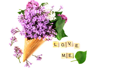 Flowers composition. Lilac in waffle cone. Flat lay, top view, copy space. Concept of proposal, love and tenderness.の写真素材