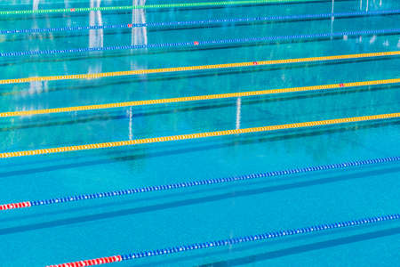 Lanes in a competition size outdoor swimming pool. Calm Water background.の写真素材