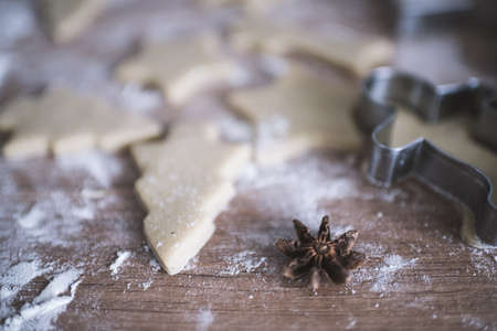 Christmas cookies preparation. Cookies cutter, dough for cookies and rolling pin on the kitchen...
