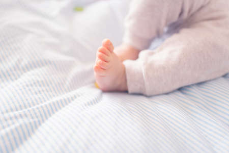 Close up of newborn baby feet and toes, selective focus.の写真素材