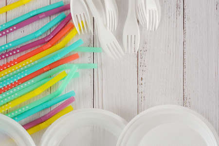 Disposable plastic plates,forks and straws. Top view, copy space. Plastic free concept. Single-use...