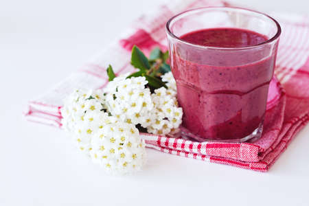 Fresh morning beetroot smoothie in glass, white background. Healthy vegan or vegetarian breakfast, seasonal detox, clean eating, alcaline diet, weight loss food concept.の写真素材