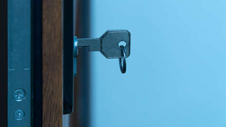 Open door with keys, key in keyhole.